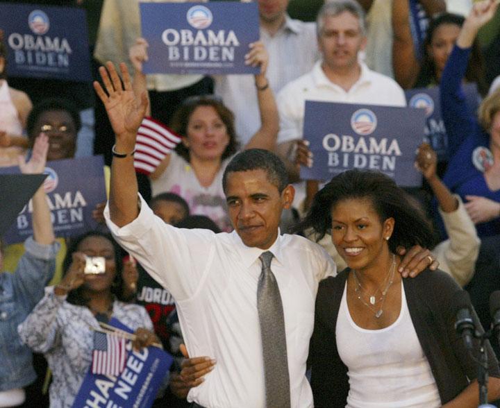 Sen. Barack Obama and his wife Michelle wave to the crowd Tuesday at a rally at Bicentennial Park in Miami.