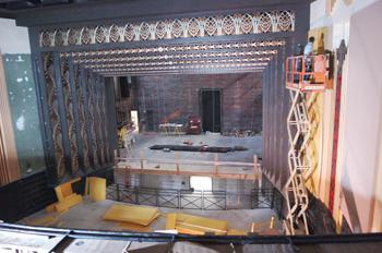 A contractor works on the theater walls in the Music and Dramatic Arts Building. The three-year renovations are set to be complete Jan 1.