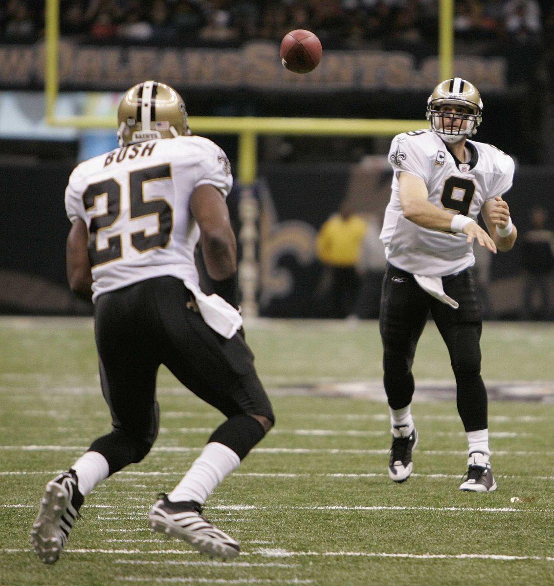 Saints running back Reggie Bush prepares to catch a pass from quarterback Drew Brees in New Orleans' 34-3 victory against the Raiders on Sunday.