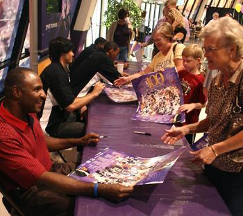 Durand “Rudy” Macklin (right) signs autographs in the PMAC on Tuesday evening during the All-Century basketball celebration.