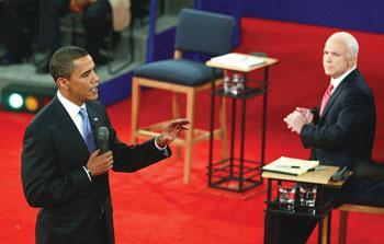 Sen. Barack Obama answers a question as Sen. John McCain listens during the presidential debate on Tuesday.