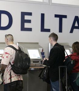 In this April 23, 2008 file photo, passengers use Delta Air Lines' self check-in counter at San Jose International Airport in San Jose, Calif.