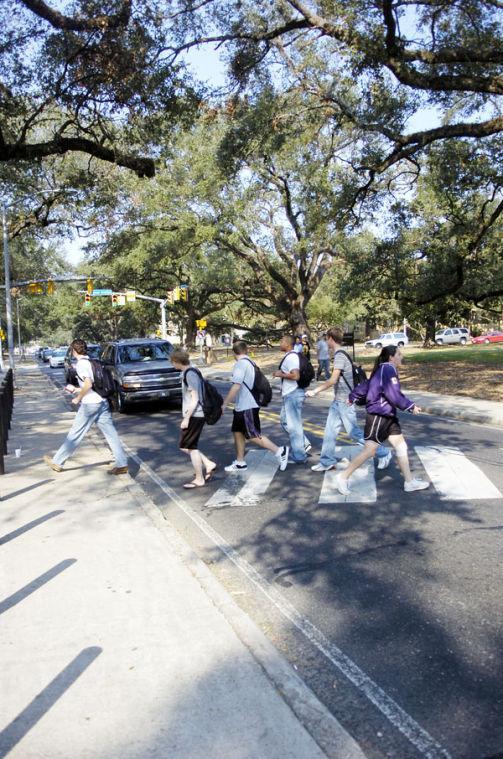 Students use the crosswalk by the Student Union to cross Highland Road on Wednesday afternoon. Renovations on four on-campus crosswalks will begin during winter break