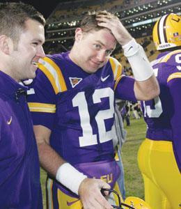 LSU quarterback Jarrett Lee (12) smiles after leading the Tigers to a come from behind 40-31 victory over Troy in an NCAA college football game in Baton Rouge, La., Saturday, Nov. 15, 2008. At left is LSU coach Ben Cohen