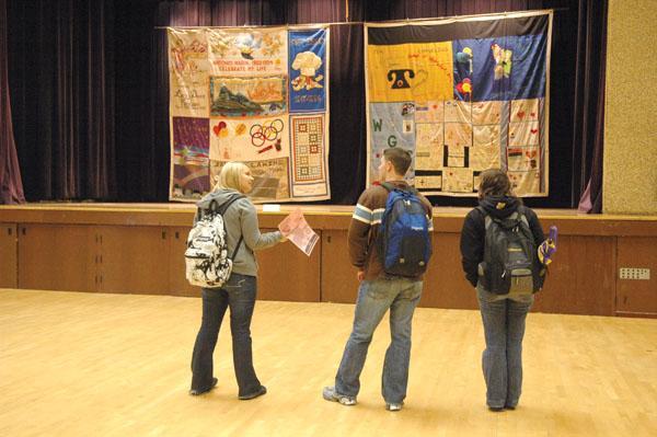 Erin Conlin, biology junior (left) Rob Farber, microbiology junior (center) and Audrey Billeaud, microbiology junior (right), view a few of the quilts displayed in the Student Union&#8217;s Cotillion Ballroom as part of World AIDS Day.