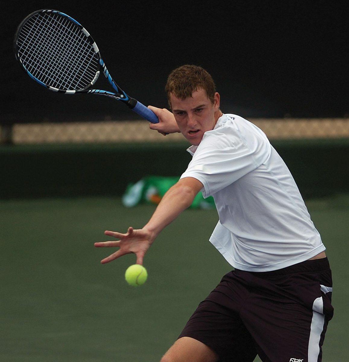 LSU senior James Cluskey, Ireland native, hits the ball back over the net during a singles match against Rice University last season.