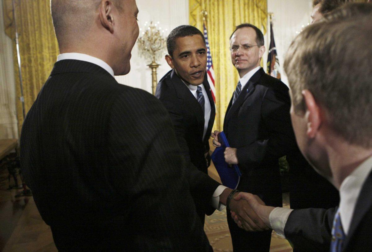 President Barack Obama shakes hands with audience members as JetBlue Chief Executive Officer David Barger [right] looks on after the president spoke about the economy Wednesday.