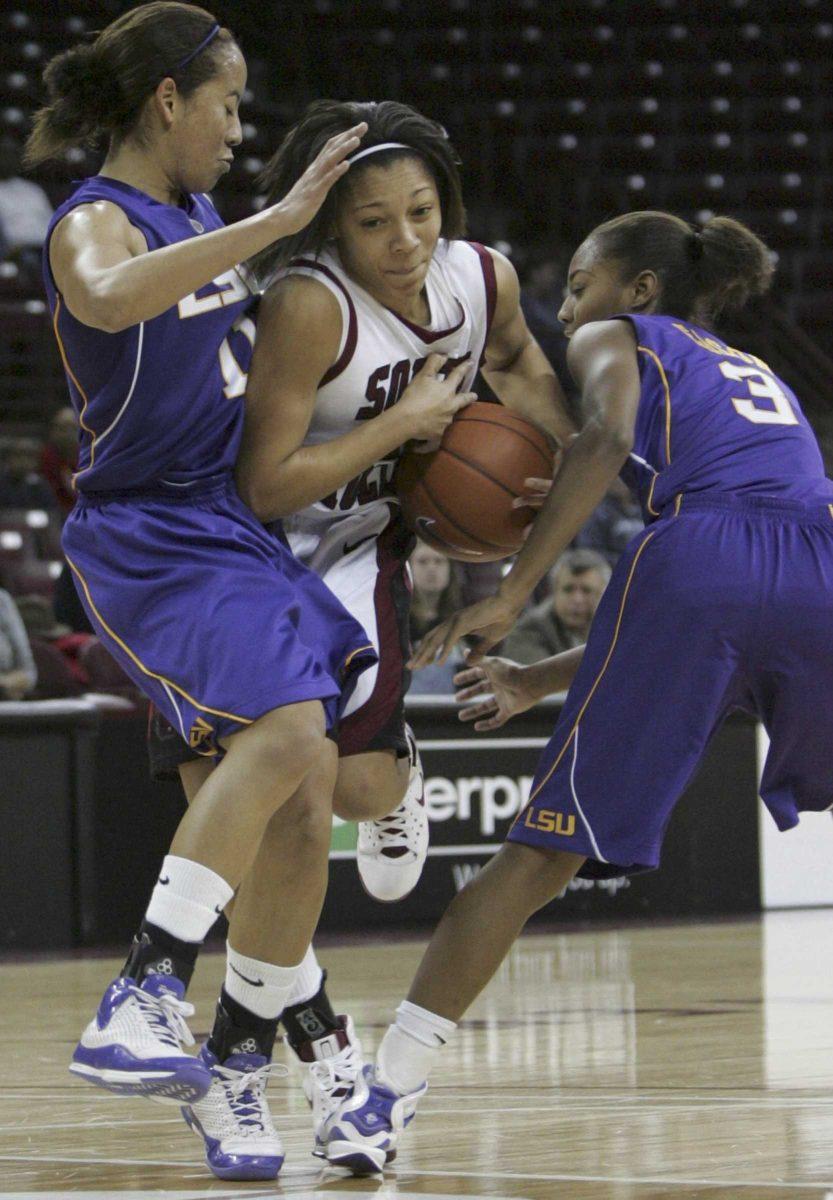 South Carolina freshman guard Lakeisha Sutton [center] is double-teamed Thursday by LSU junior guard Andrea Kelly [left] and sophomore guard Latear Eason [right] during the Lady Tigers&#8217; 63-56 road win Thursday.