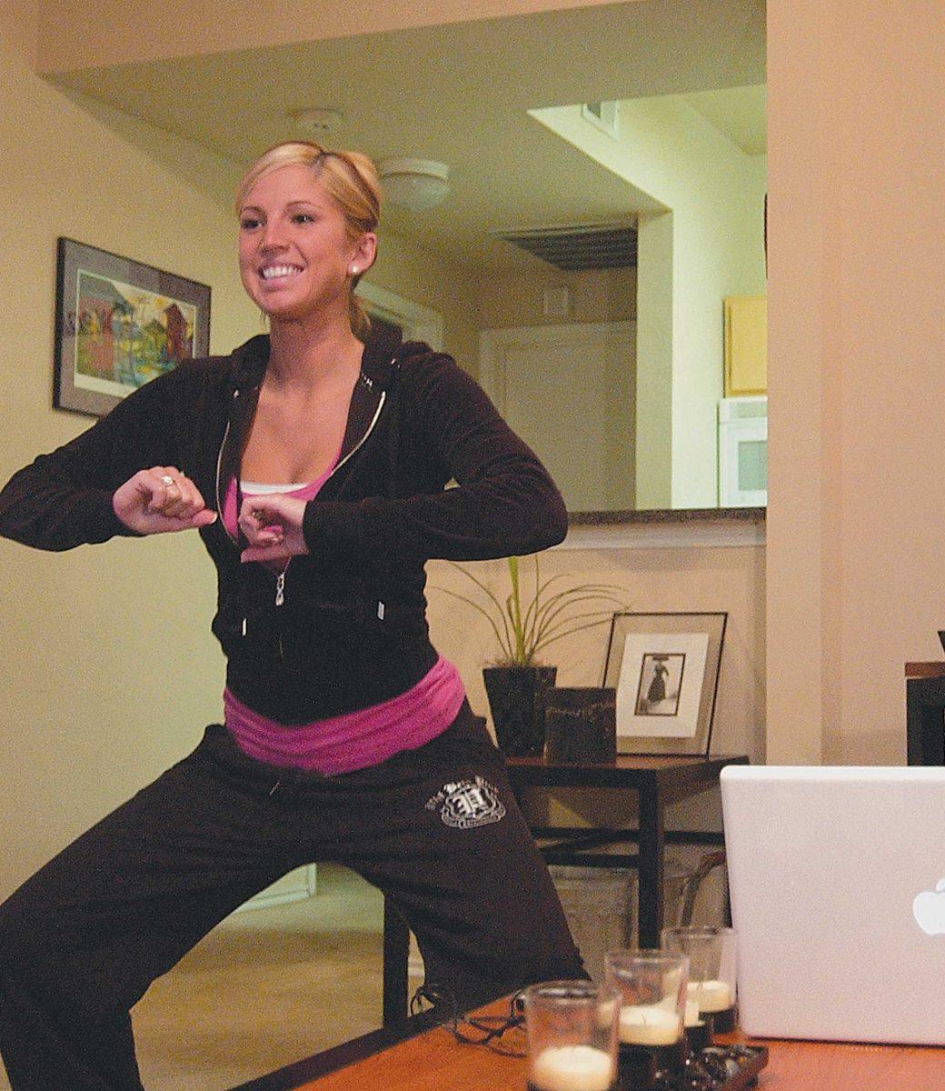 Kimberly Russell, nursing sophomore, works out in her apartment using one of the UREC&#8217;s online classes. The budget allows new classes to be added every few weeks.