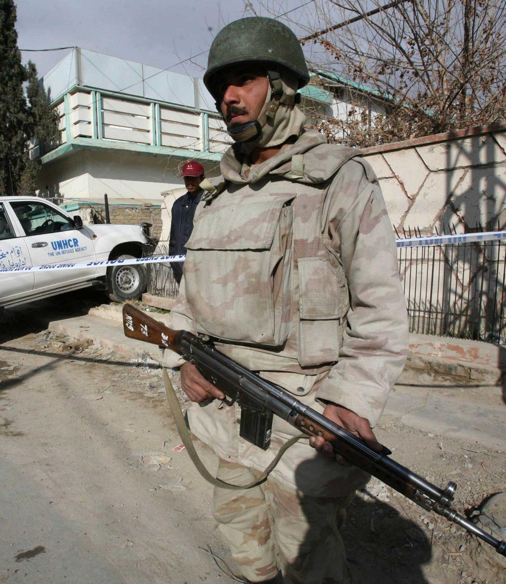 A Pakistani paramilitary soldier stands guard next to a vehicle rammed against a wall, where American U.N. official was kidnapped, in the main southwest city of Quetta, Pakistan on Monday, Feb. 2, 2009. Gunmen kidnapped an American U.N. official and killed his driver in southwest Pakistan on Monday, police said, underscoring the security threat in a country wracked by al-Qaida violence and rising criminality.