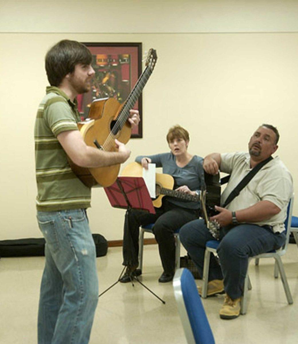 Eric Johns, guitar leisure class instructor, teaches students and members of the Baton Rouge community guitar fundamentals Sunday in the Student Union.