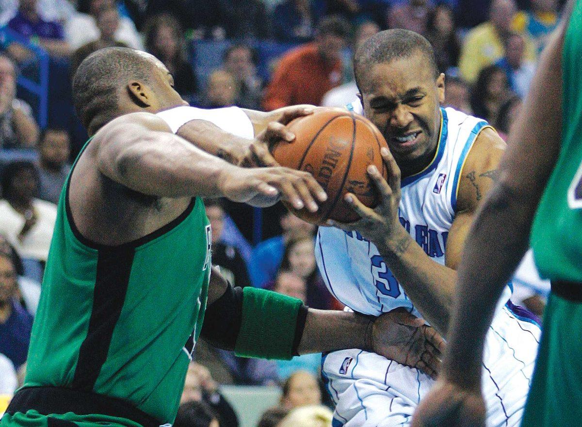 New Orleans Hornets forward David West, right, battles Boston Celtics forward Glen Davis, left, in the first half of their game in New Orleans on Wednesday. The Hornets lost 89-77.