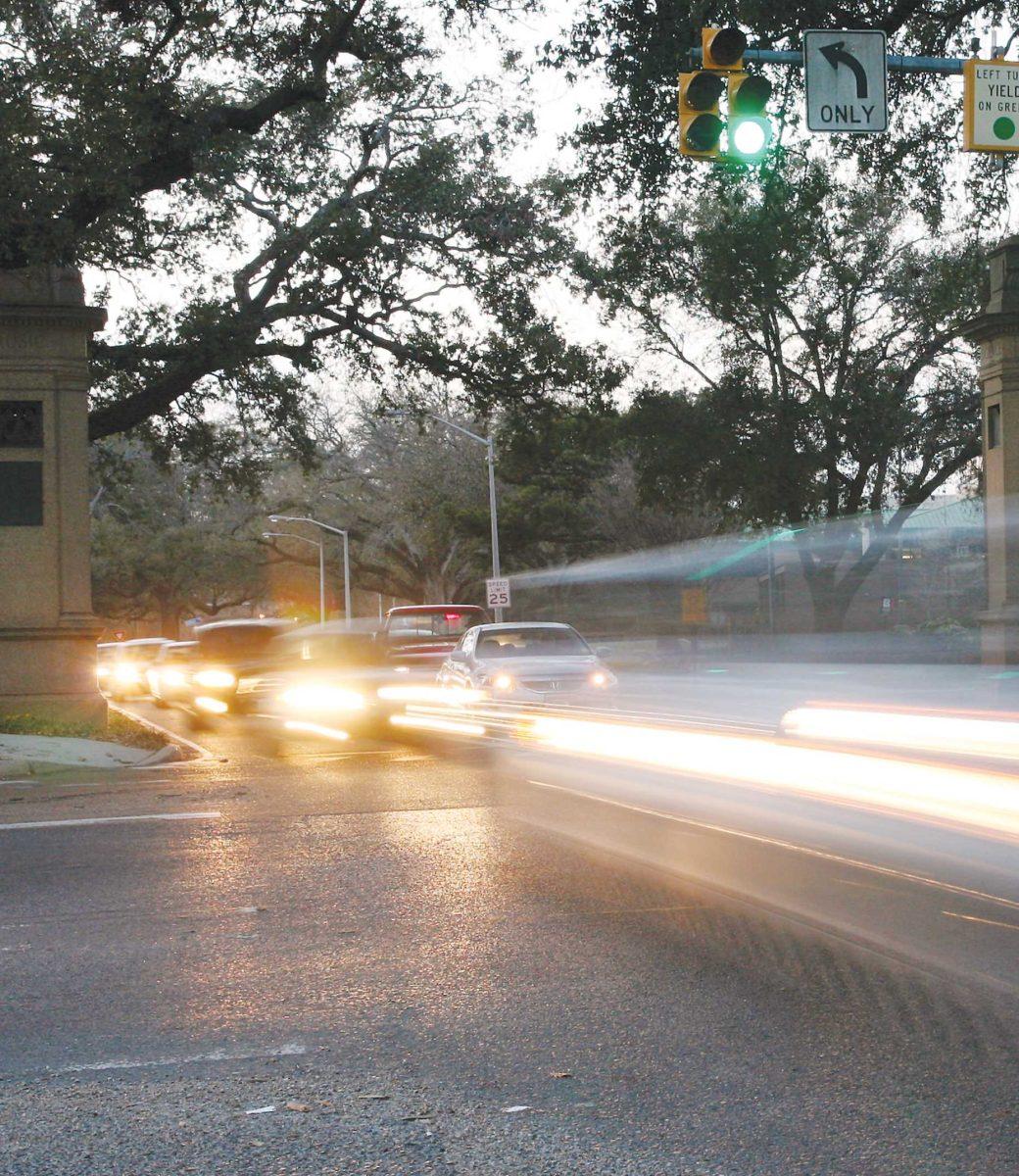 Cars travel through the intersection of E. Parker Boulevard and Highland Road on Monday during peak traffic hours.