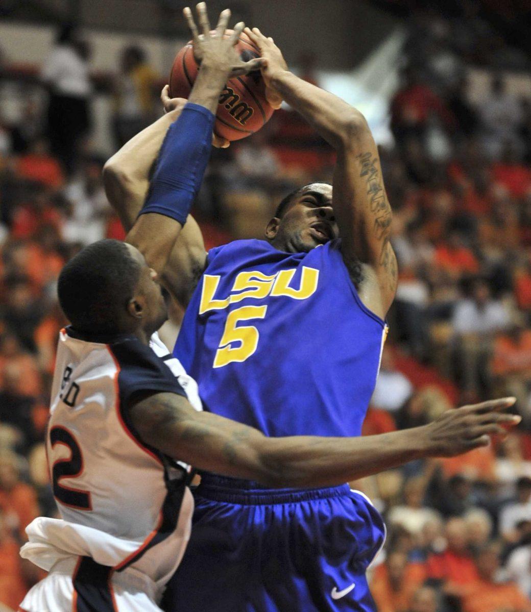 LSU's Marcus Thornton is fouled by Auburn guard DeWayne Reed during an NCAA college basketball game at Beard-Eaves Memorial Coliseum in Auburn, Ala., Saturday, March 7, 2009.