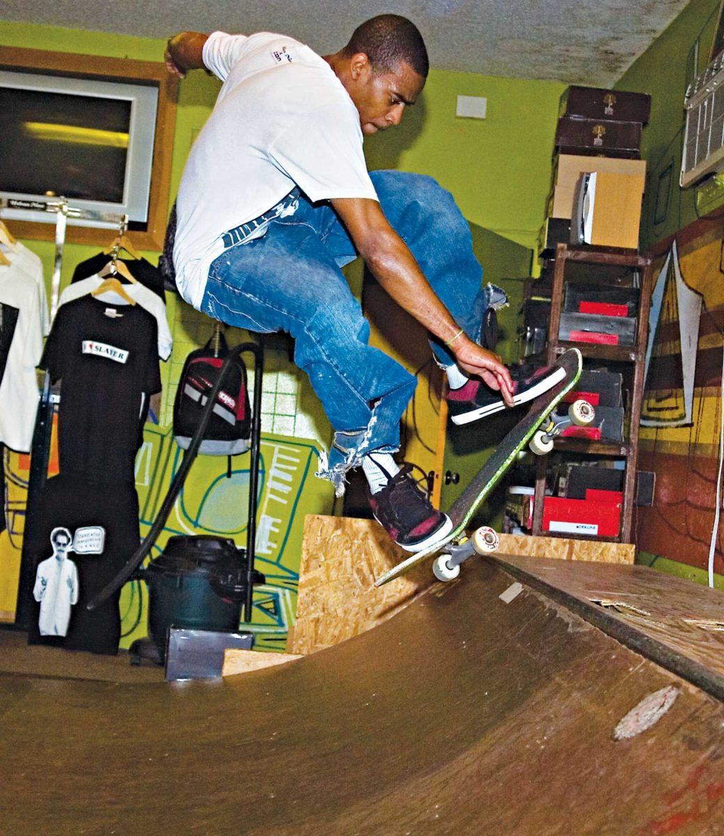 Urban 9 employee Parker Barnes grabs his board as he ollies on the pipe Wednesday at the skate shop&#8217;s indoor mini ramp.