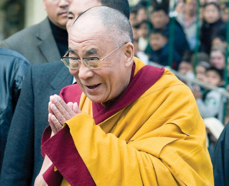 Tibetan leader the Dalai Lama greets the crowd gathered to welcome him as he arrives March 8 at the Tsuglakhang temple in Dharmsala, India.