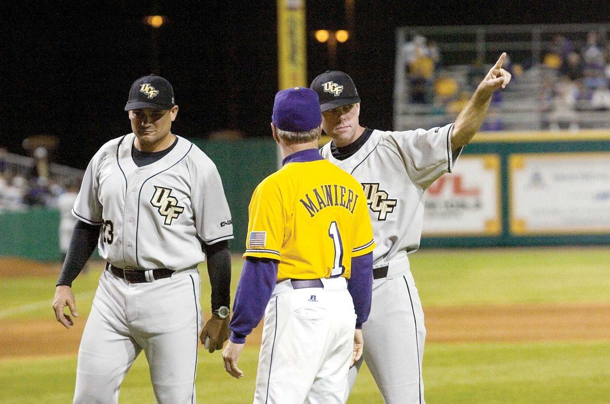 LSU coach Paul Mainieri presents former LSU assistant coaches and current UCF coaches Terry Rooney (right) and Cliff Godwin (left) on Friday night at Alex Box Stadium with their 2008 College World Series rings.