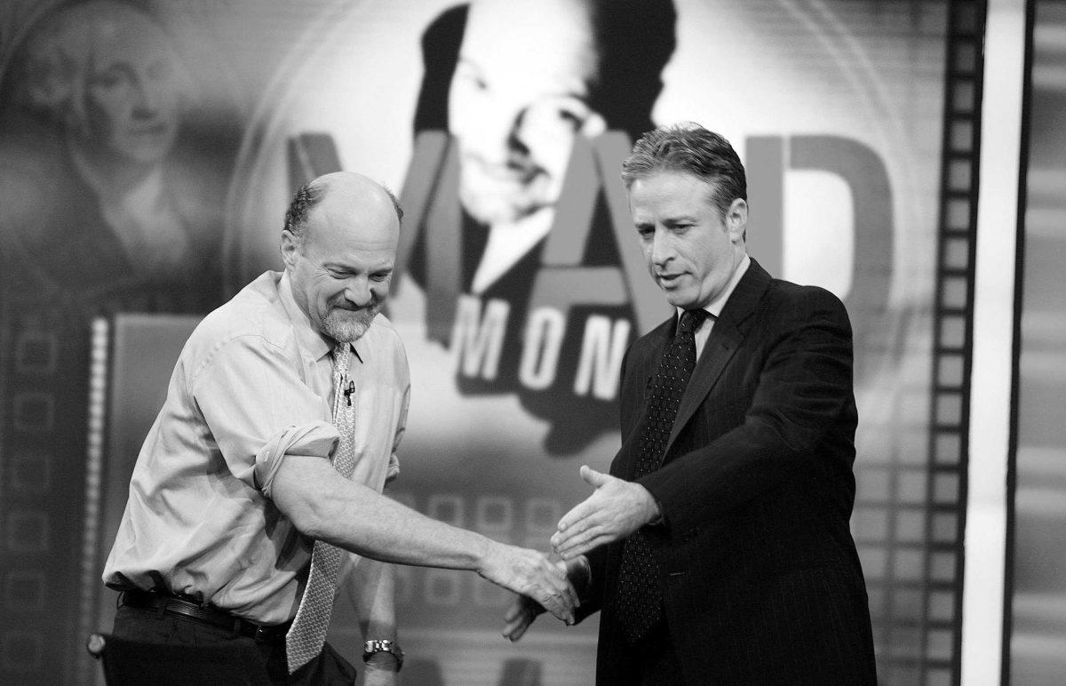 Jim Cramer (left), host of CNBC&#8217;s &#8220;Mad Money,&#8221; is welcomed by Jon Stewart (right) on March 12 during an appearance on Comedy Central&#8217;s &#8220;The Daily Show.&#8221;