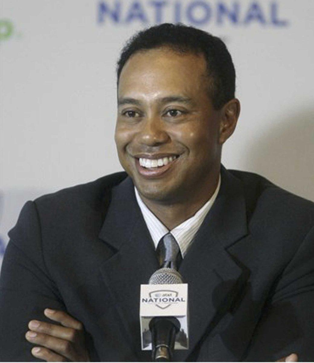 Tiger Woods smiles during a news conference where he talked about the upcoming AT&amp;T National golf tournament he hosts in July, Monday, April 20, 2009, in Bethesda, Md,