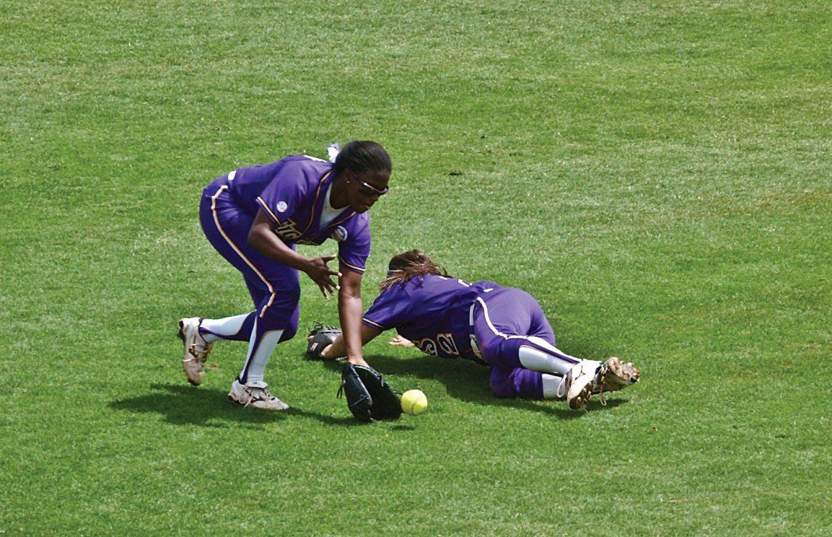 Left fielder Jazz Jackson (left) comes up to field the ball that got past short stop Juliana Santos (right) on Sunday during the Tigers&#8217; 12-0 loss to Florida.