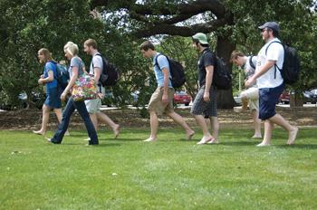 A group of students who went without shoes for a day take a shoeless walk together on the Parade Ground on Thursday.