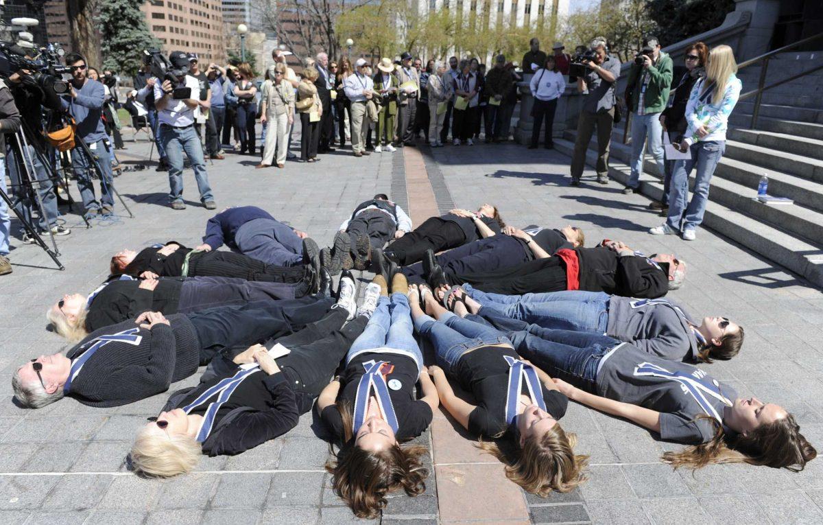 Thirteen people lie down in memory of the Columbine school shooting victims on the 10th anniversary of the attack.