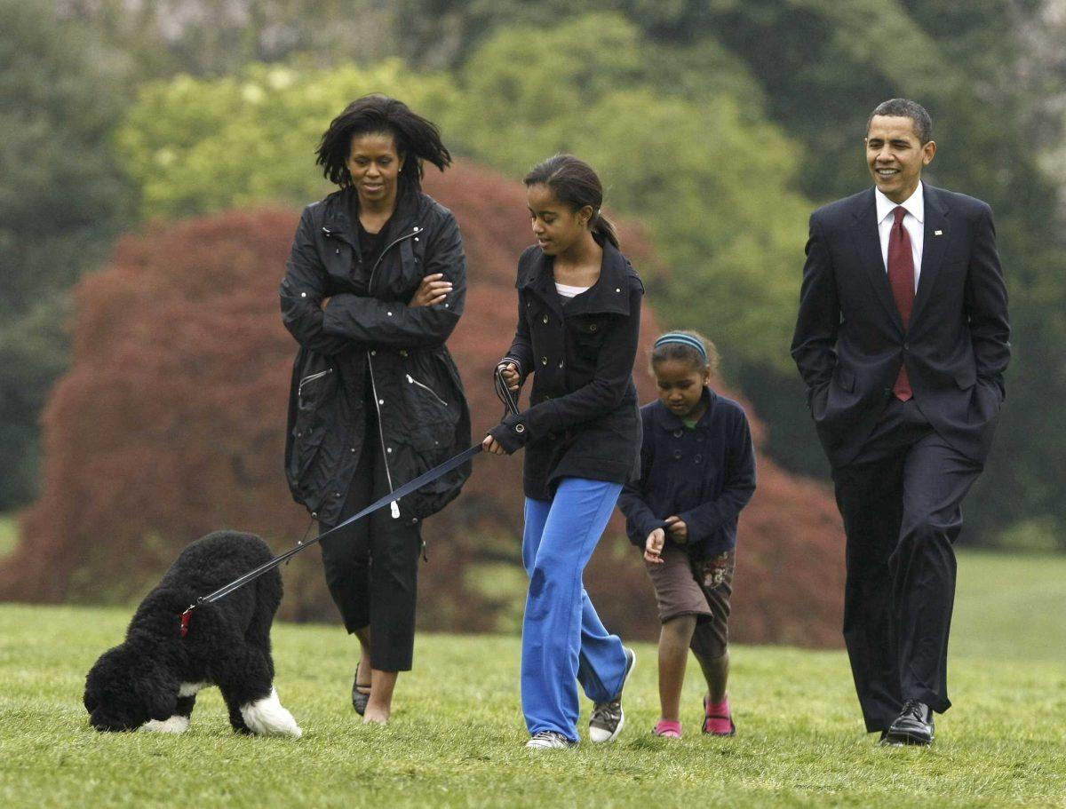 Malia Obama walks with her family&#8217;s new dog, Bo, as President Barack Obama, first lady Michelle Obama and Sasha follow on the South Lawn of the White House in Washington on Tuesday.