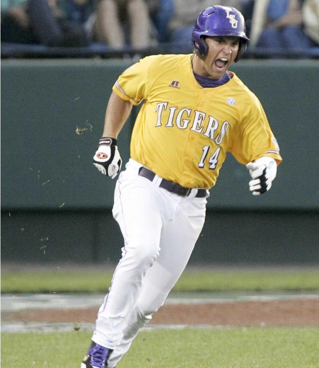 LSU's Sean Ochinko celebrates as he rounds the bases after hitting a three-run home run against Virginia in the fifth inning of an NCAA College World Series baseball game, in Omaha, Neb., Saturday, June 13, 2009.