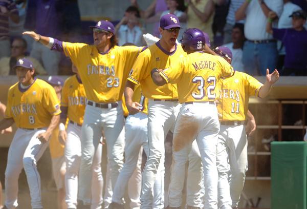 Senior Chris McGhee is greeted at home plate after scoring against Southern on Friday.