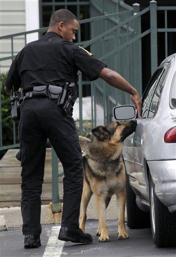 An Annapolis, Md. fire marshal investigator uses a dog to search a vehicle Wednesday, June, 10, 2009 outside the Annapolis, Md. condominium building believed to be the home of James Von Brunn, an elderly man who allegedly opened fire with a rifle Wednesday at the Holocaust Museum in Washington.