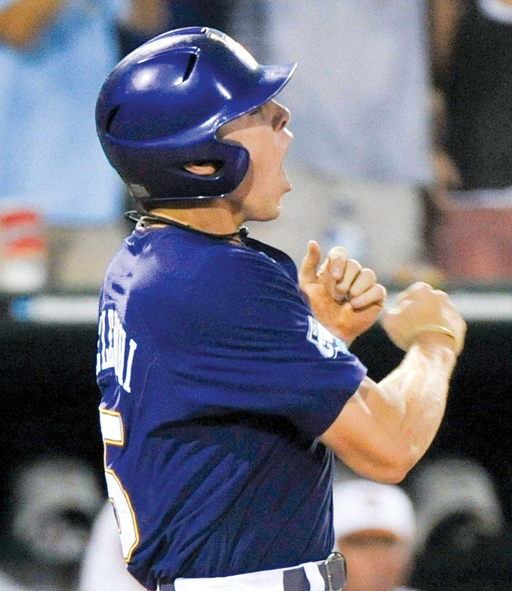 LSU senior third baseman Derek Helenihi celebreates after scoring the tying run in the ninth inning of the first game of the College World Series best-of-three championship series on Monday. The Tigers went on to win the game, 7-6, in 11 innings.