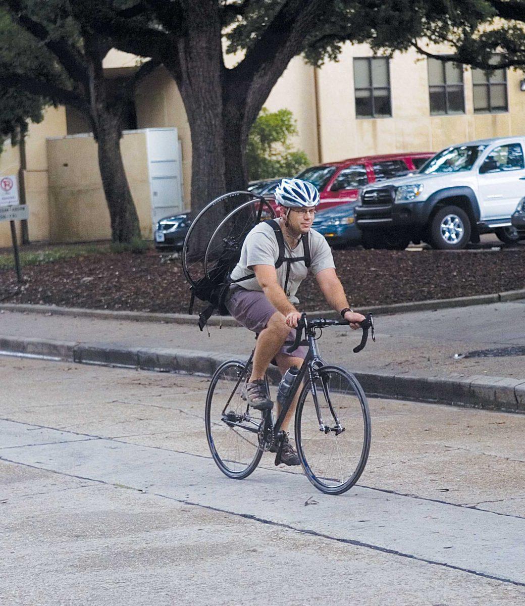 <p>A cyclist bikes down Tower Drive on Monday. The next phase of Easy Streets calls to add more bike routes to campus and shut down some streets.</p>