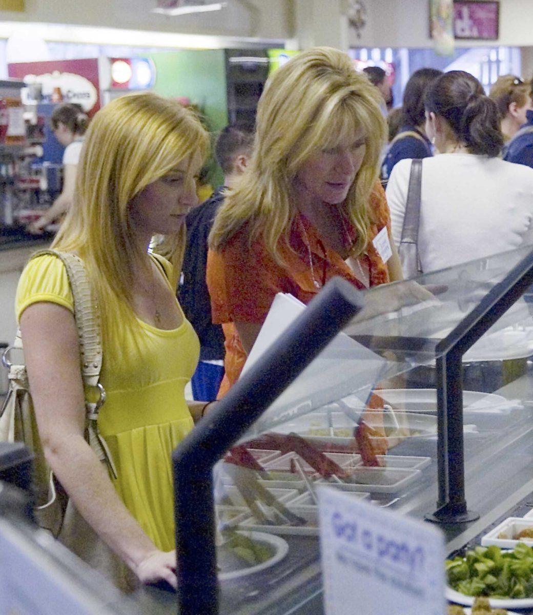 <p>Psychology junior Sarah Risher and Suzette Pellefrini choose toppings Wednesday at the Tiger lair in the Student Union.</p>