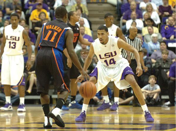 Former LSU guard Garrett Temple defends Florida guard Erving Walker during the Tigers' 81-75 victory against the Gators on Feb. 24.