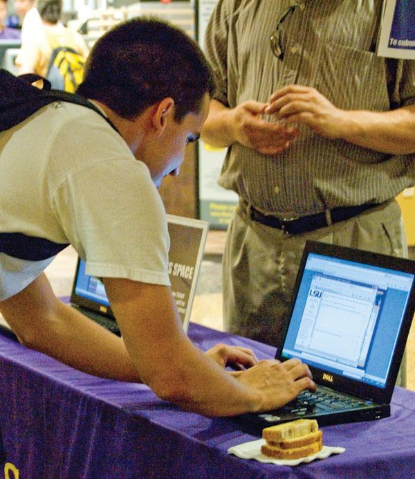 Jason Arroyave, mechanical engineering junior, casts his vote for the name of the new lounge Wednesday in the basement of the Student Union.