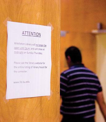 A sign on a Middleton Library door announces changes to its hours of operation.