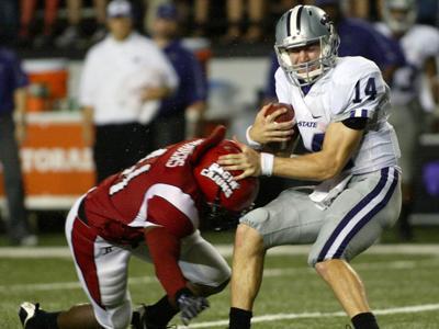 Kansas State quarterback Carson Coffman, 14, is tackled by Louisiana-Lafayette&#8217;s Antwyne Zanders during the game Saturday at Cajun Field in Lafayette, La.