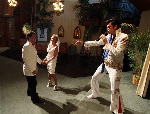 Brian Mills, right, an Elvis impersonator, marries Richard Johnson and Cheryl Bell of Peoria, Ariz. at the Viva Las Vegas wedding chapel Wednesday, Sept. 9, 2009 in Las Vegas. The date is proving popular at Las Vegas wedding chapels.