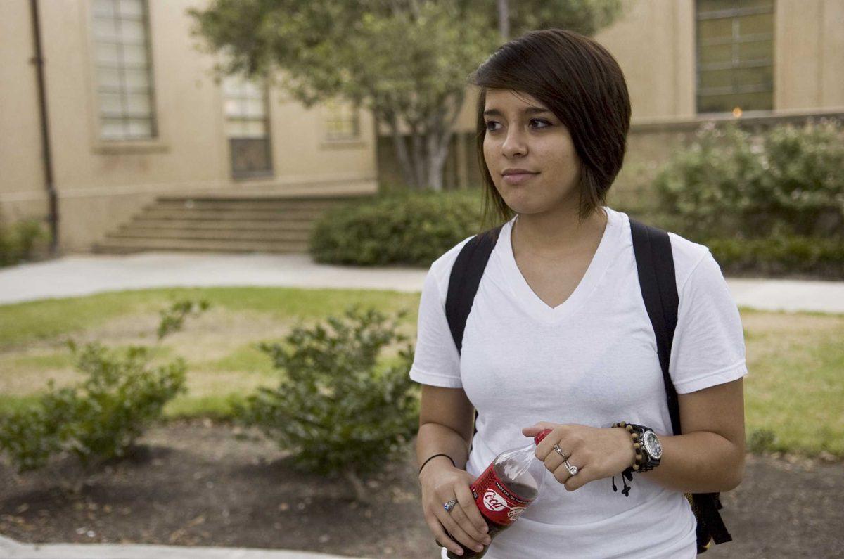 Karla Delgado, computer engineering freshman, drinks a coke on Tuesday. A proposed sugary beverage tax could increase soft drink prices a cent per ounce.