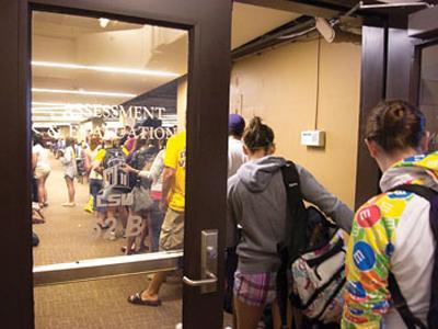 Students wait in line Tuesday evening to register to take computer-based tests at the Himes Hall Testing Center. The Center has received a large increase in student traffic as a result of more teachers assigning computer tests.