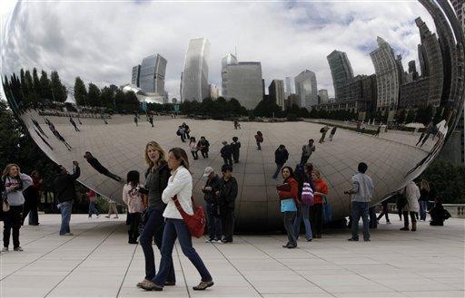 Visitors are reflected in Anish Kapoor's sculpture called "Cloud Gate" by the city, and "the bean" by everyone else, in Chicago's Millennium Park on Tuesday, Sept. 29, 2009. President Barack Obama will head to Copenhagen this week to lobby the International Olympic Committee for Chicago to host the 2016 Olympics.