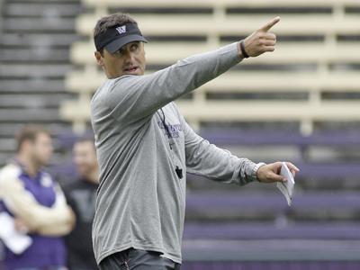 New Washington head coach Steve Sarkisian points downfield as he works with his team on practice drills, Monday, Aug. 10, 2009, at Husky Stadium in Seattle, on the first day of NCAA college football practice.