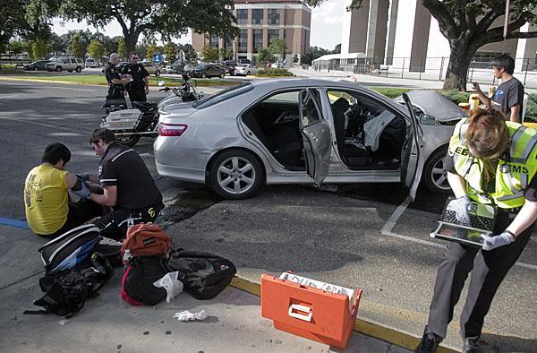 A paramedic checks on Phuong Nguyen, computer engineering sophomore, who was involed in a two car wreck early Monday evening on South Stadium Drive.