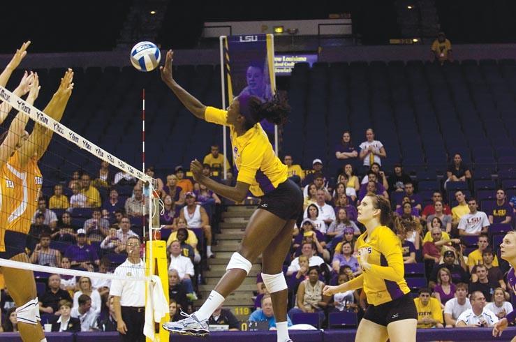 Senior middle blocker Brittnee Cooper (25) spikes the ball against Tennessee in the Tigers&#8217; 3-2 win against the Volunteers on Sept. 18.