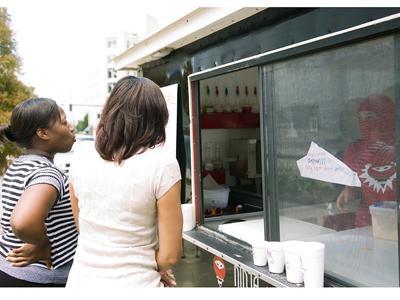 &#8220;Ninja Maggie,&#8221; political science sophomore, takes an order from customers Sept. 1 on Main Street.