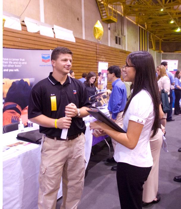 Diane Ho, mechanical engineering graduate student, speaks with a recruiter from Chevron at Wednesday's Career Expo in the Carl Maddox Field House.