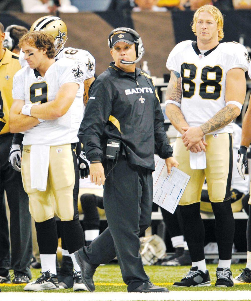 New Orleans Saints quarterback Drew Brees, left, and tight end Jeremy Shockey, right, join coach Sean Payton, center, in watching the action Sept. 3 in the first half of the game against the Miami Dolphins.