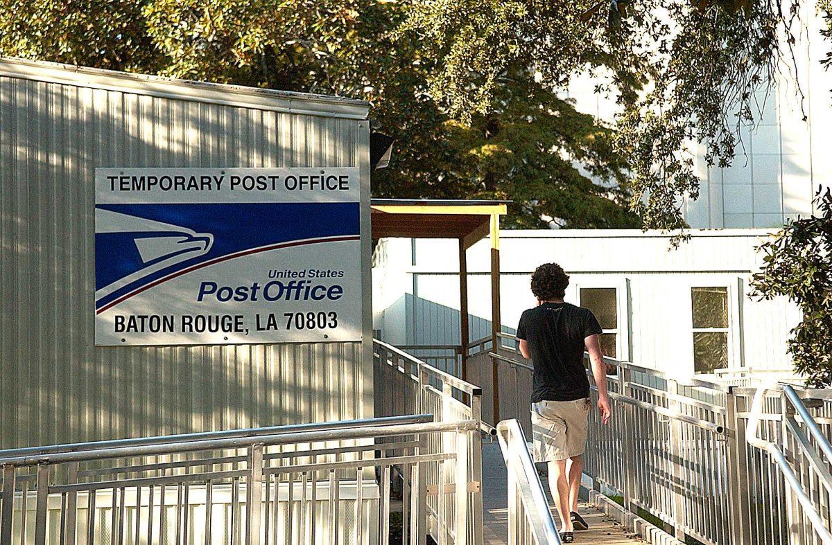 A student visits the temporary post office behind the Faculty Club on Thursday. The on-campus branch is in danger of being closed because of federal budget cuts.