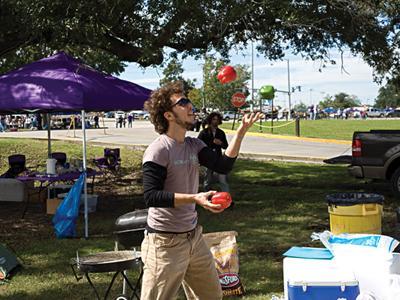 Matt Wyatt, natural resource ecology and management sophomore and ECO at LSU co-vice president, juggles between helping out with the green tailgate before the Auburn game Saturday.