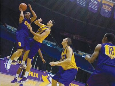 Junior point guard Bo Spencer, left, goes up for a shot as sophomore forward Garrett Green attempts to defend him Wednesday in the PMAC during the Tigers&#8217; Purple and Gold Scrimmage.